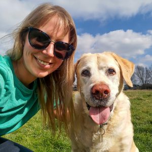 A happy senior labrador smiles as he poses for a selfie with his dog walker, Steph, in Cambridge.